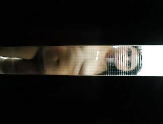 Nude woman behind glass