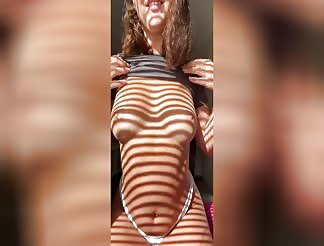 Hot wife teasing her boobs in the shadows