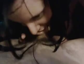 Tattooed brunette licks cock under cover 